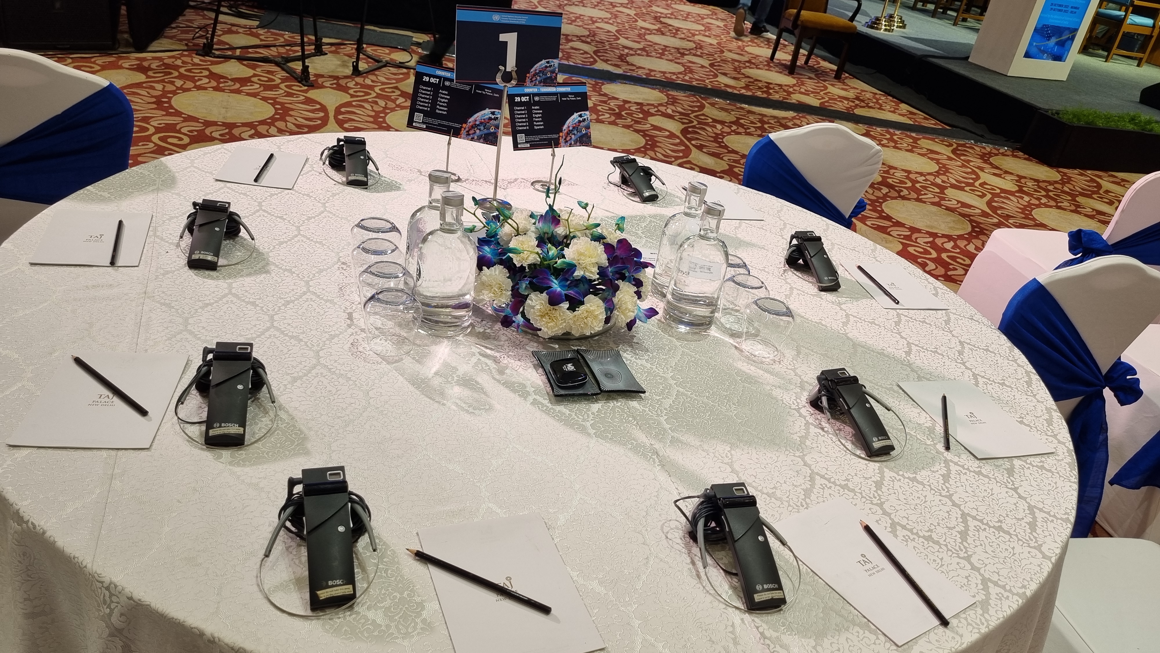 Delegate table set with per-seat interpretation receivers and channel guides for the six UN languages