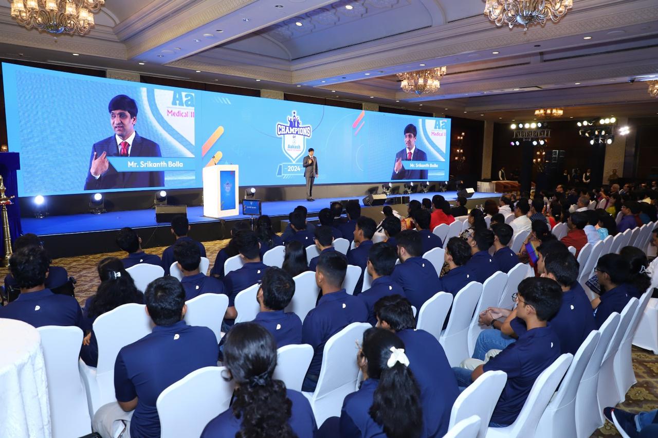 Students seated in uniform watching the keynote address at Champions of Aakash