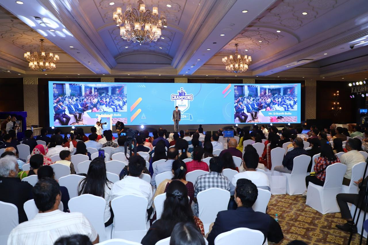 Wide view of the Champions of Aakash ballroom with a full audience and live IMAG on the LED wall