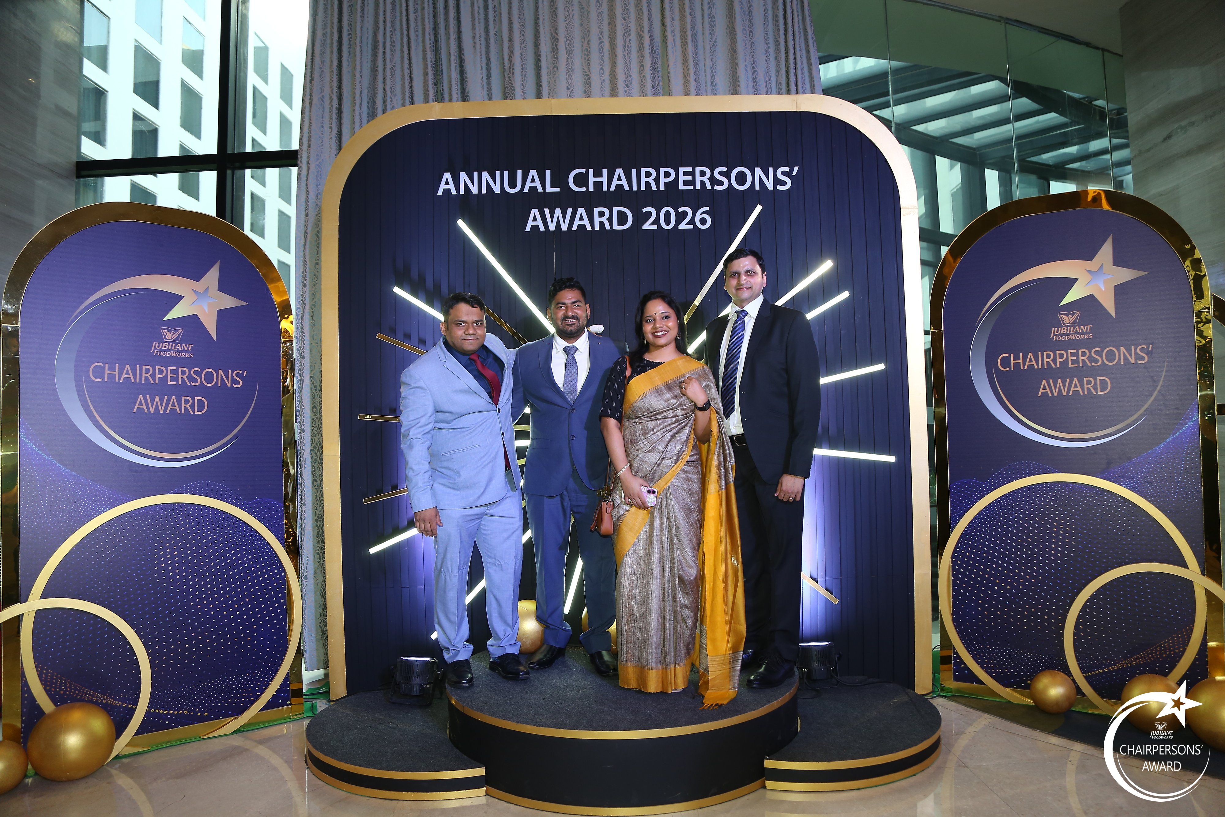 Guests photographed on the branded riser at the Annual Chairpersons' Award arrival area